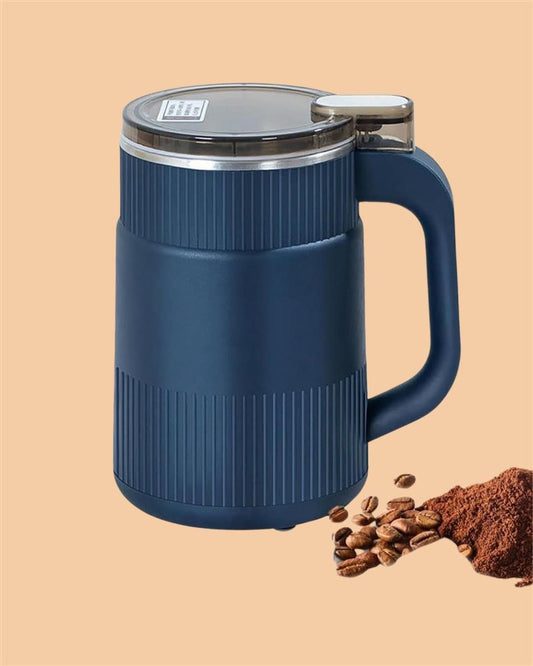 Blue multi-purpose grain and nut grinder with handle and transparent lid next to coffee beans and ground coffee